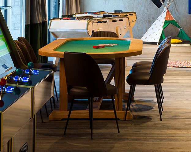 Hospitality game room with custom reclaimed oak table for leisure interior